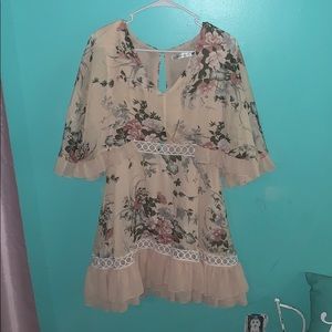 A cream colored floral dress by Dress Forum